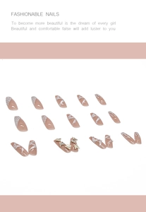 Detail of almond press-on nails with 3D gold butterflies, pearls and silver glitter