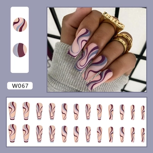 Detailed view of matte coffin press-on nails with abstract wave lines and purple tones