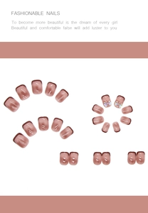 Detailed view of dusty rose press-on nails with brown French tips and bow accents