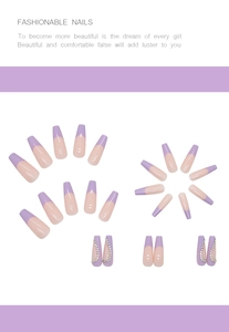 Detail of long coffin purple french tip press-on nails with rhinestone accents