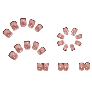 French tip press-on nails in sheer pink and dark coffee with laser 3D bow accents