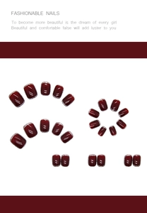 Detailed view of deep red press-on nails with elegant silver glitter edges on white base