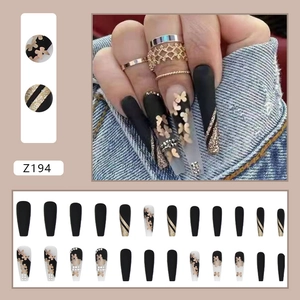 Macro view of 24pcs matte black ballerina press-on nails with gold butterfly and rhinestone
