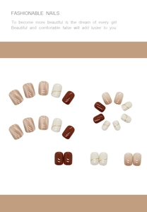 Detail showing mocha brown and nude press-on nails with golden streamlined artistic paint