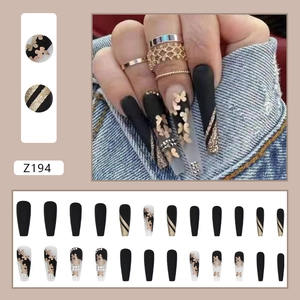 Long ballet press-on nails with black matte finish and gold butterfly rhinestone designs