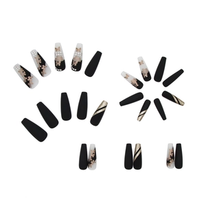 Long ballerina press-on nails featuring matte black, gold butterfly, and pearl accents