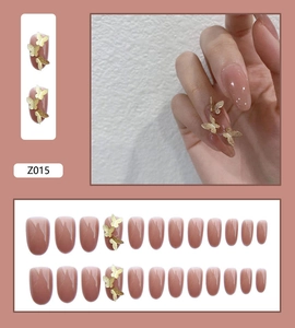 Handmade press-on nail kit in nude pink with elegant 3D golden butterfly ornaments
