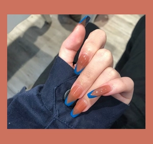 Close-up of French V-shape tip press-on nails in jelly brown and Klein blue coffin style