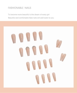 Detail of long coffin press-on nails with pink cat-eye finish and rhinestone accents