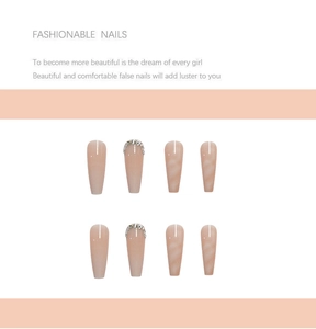 Macro detail of long ballet press-on nails featuring pink gradient and rhinestone accents