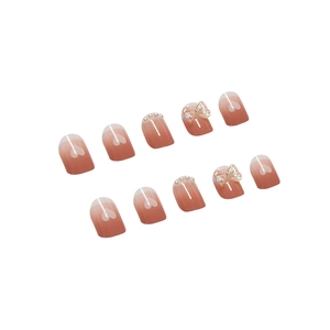 Pink gradient press-on nails with 3D butterfly, pearls, and heart details in 10-piece set