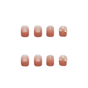 Pink and white gradient press-on nails with 3D bows, pearls, and heart patterns