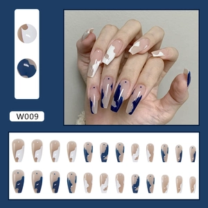 Coffin press-on nails set with blue, white, and nude geometric patterns and dot accents