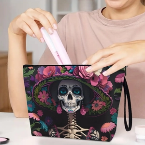 Day of the Dead makeup bag with floral skull pattern and handy wristlet strap