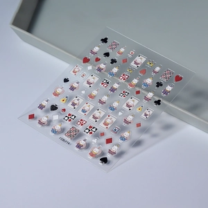 Detailed macro of 3D embossed nail art stickers with bear and playing card patterns