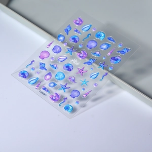 Macro detail of 3D embossed ocean shell and starfish nail art stickers with pearls