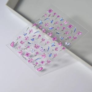 Detailed close-up of 3D embossed purple butterfly and bird nail stickers on a clear sheet