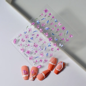 3D embossed butterfly and flower nail art stickers with pearl accents on orange nails