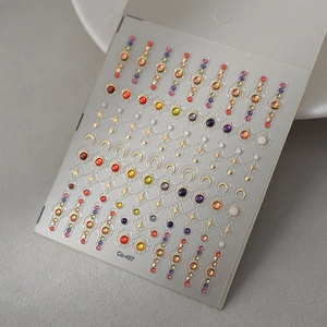 Detailed view of 5D embossed nail stickers featuring gold stars moon and colorful gems
