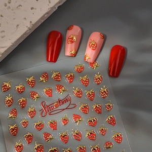Detailed view of red strawberry 3D nail art stickers with golden metallic embossed edges