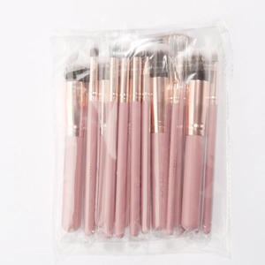 Detail of 15-piece makeup brush set with pink handles and rose gold ferrules in packaging