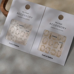 3D embossed nail stickers with gold and silver crystal designs in elegant white packaging