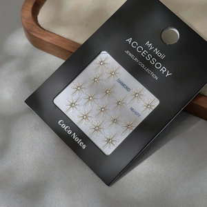 Sparkling gold star nail art stickers with rhinestones and self-adhesive back in package