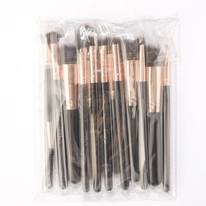Detailed macro view of 16-piece makeup brush set with rose gold ferrules in clear bag
