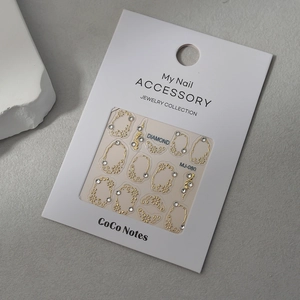 Golden hollow nail art frame stickers with rhinestones on a white display card