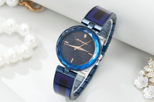 Detail of starry sky watch dial with blue faceted crystal bezel and rose gold hands