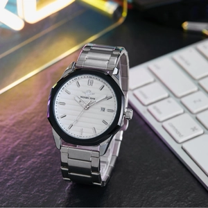 Business men's quartz watch with steel strap and white dial on a modern desk