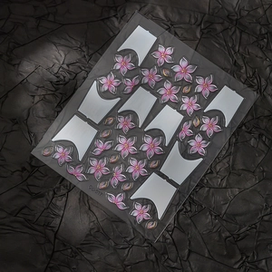 Detail of pink cherry blossom nail stickers with gold accents and 3D floral relief