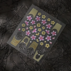 Macro shot of Co-518 nail stickers with pink cherry blossoms and gold shell accents