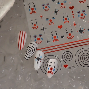 Clown circus nail art stickers with red heart and star patterns on silver background
