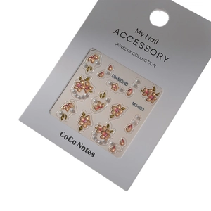 Floral nail stickers with pearls and gold leaf accents in professional packaging