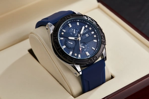 Close-up of blue chronograph watch dial with date display and silicone strap in gift box