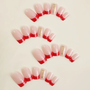 Unghie finte French rosse classiche con stelle dorate e base semitrasparente