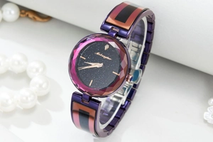 Detail of purple starry sky watch with faceted crystal lens and rose gold hands