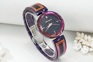 Detail of starry sky dial and multifaceted cut glass on women's purple quartz watch