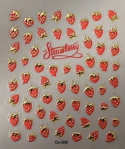 Macro detail of 3D embossed red strawberry nail art stickers with golden leaf patterns