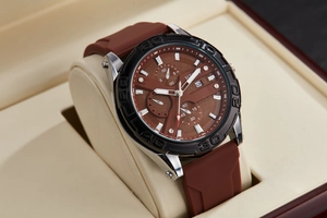 Detail of multi-function chronograph watch with brown dial and silicone strap in luxury box