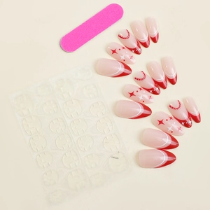 Detail of red and white almond false nails with star patterns and adhesive tabs