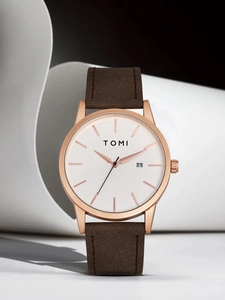 Close-up of TOMI rose gold watch with white dial, date window, and brown leather strap