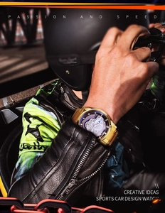 Close-up of golden racing-style watch with hollow dial against professional gear