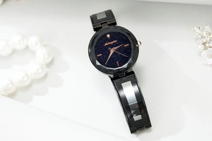 Close-up of starry sky dial with rose gold hands and faceted bezel on women's watch