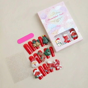 Detail of Christmas press-on nails set with 3D Santa and reindeer motifs in red box