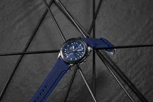 Macro view of blue dial chronograph with three sub-dials and grey metal case