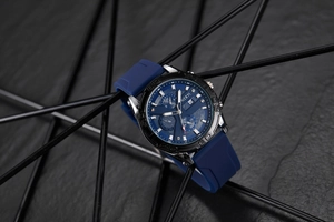 Macro detail of men's chronograph watch with blue dial and date display function