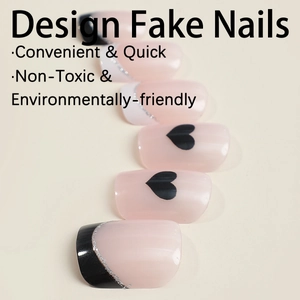 Press on nails featuring nude pink heart designs and black and white French tips