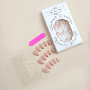 Short square press-on nail kit with gold French tips, glue tabs, and nail file